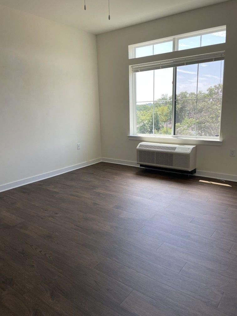 Spotless bedroom with shining hardwood floors cleaned by Grace Shine