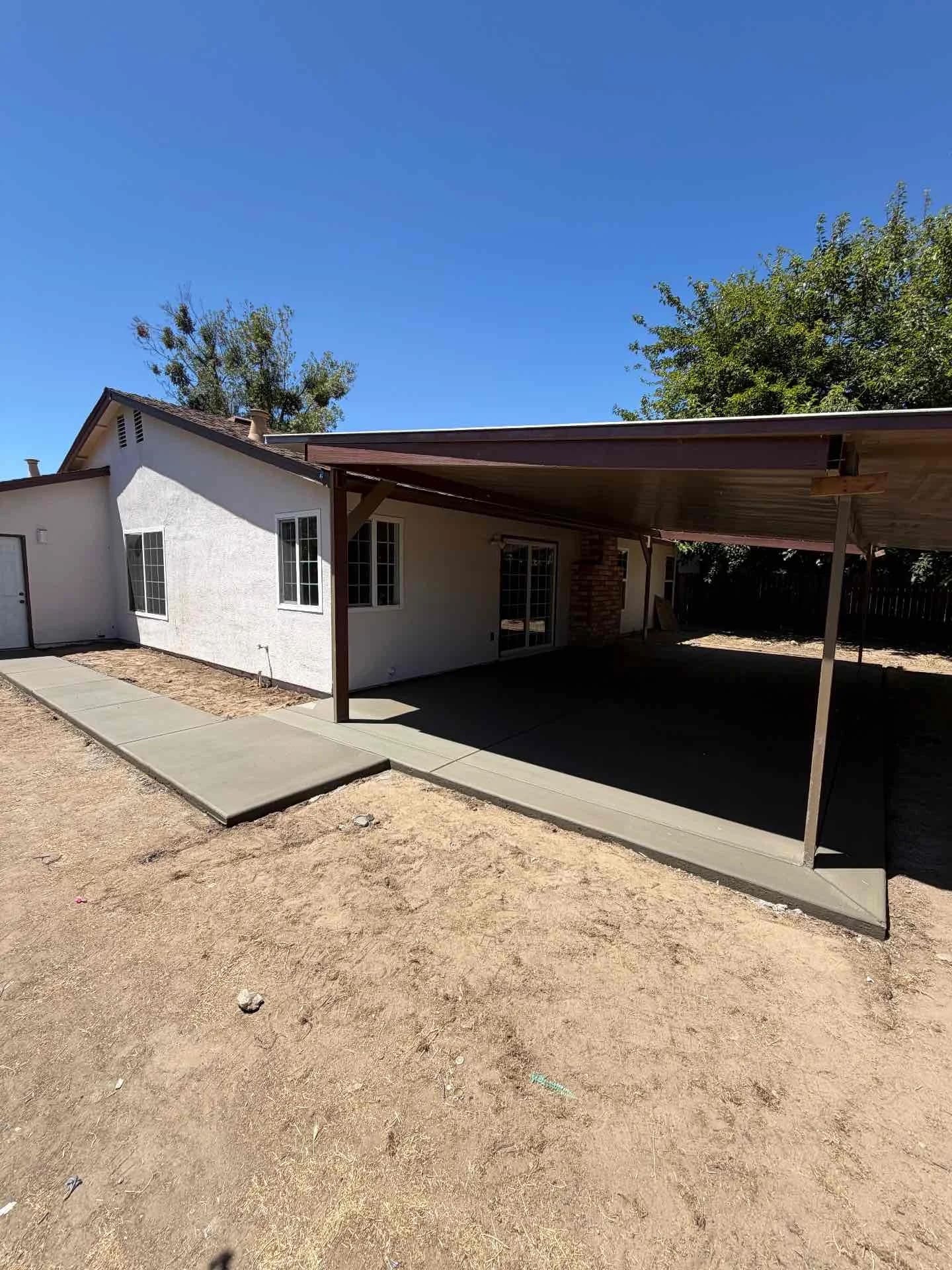 Poured concrete covered patio slab and connecting residential perimeter walkway