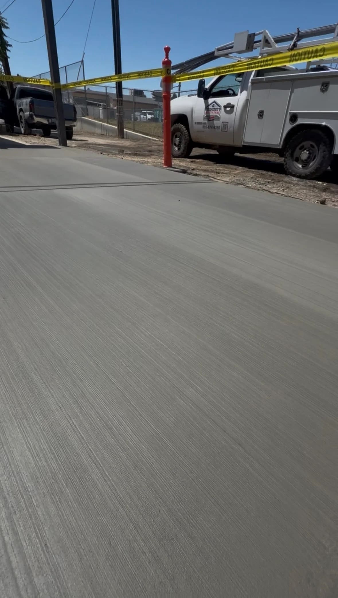 Freshly finished concrete street access driveway with broom texture
