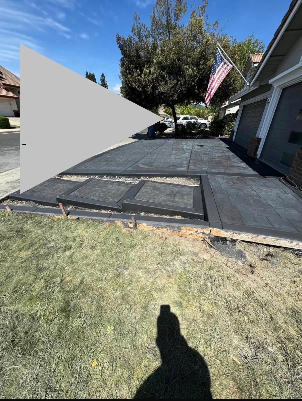 Tiered stamped concrete driveway and entryway with dark borders