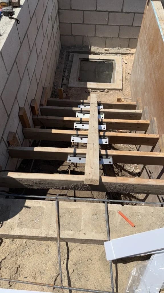 Formwork and framing preparation for poured concrete steps between retaining block walls