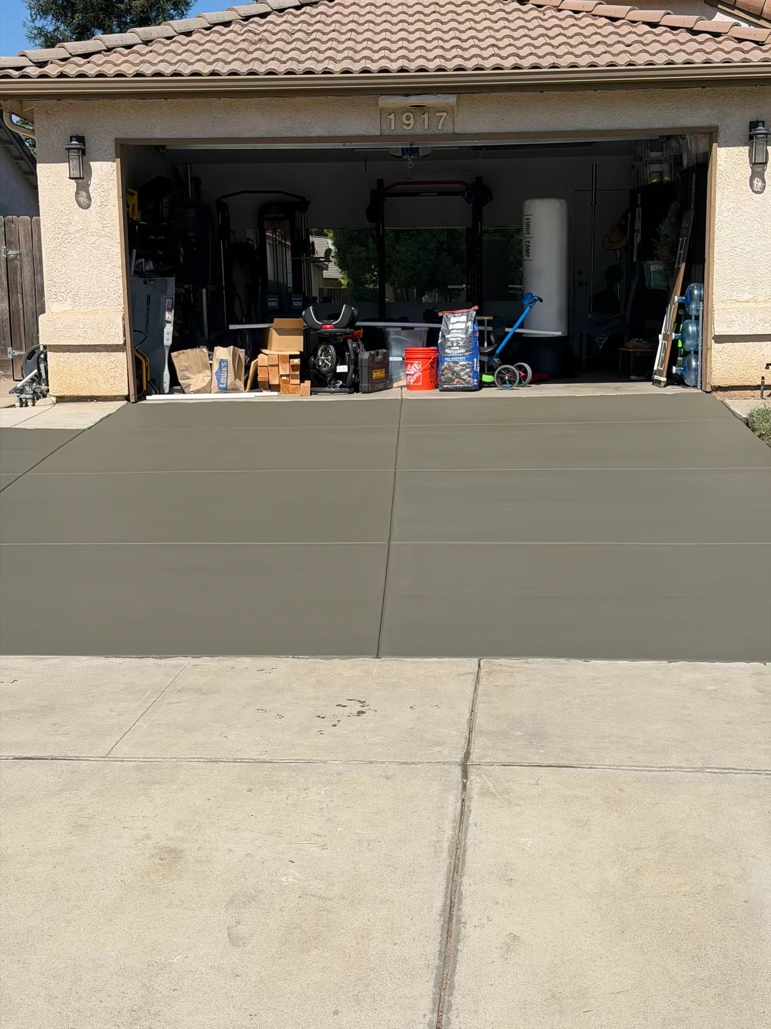 Finished residential concrete driveway installation in front of garage