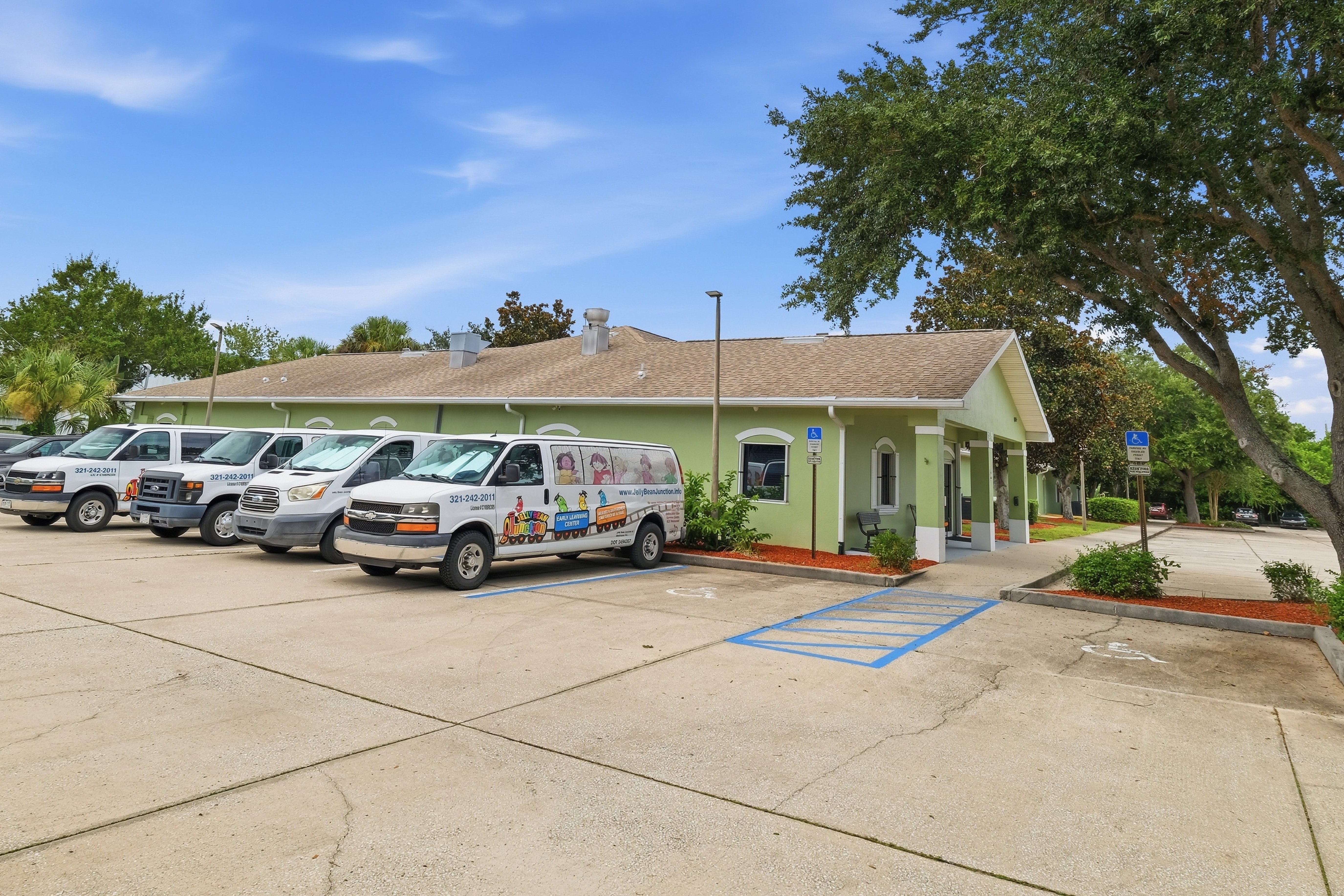 The Jelly Bean Junction main facility with student transportation vans and dedicated parking