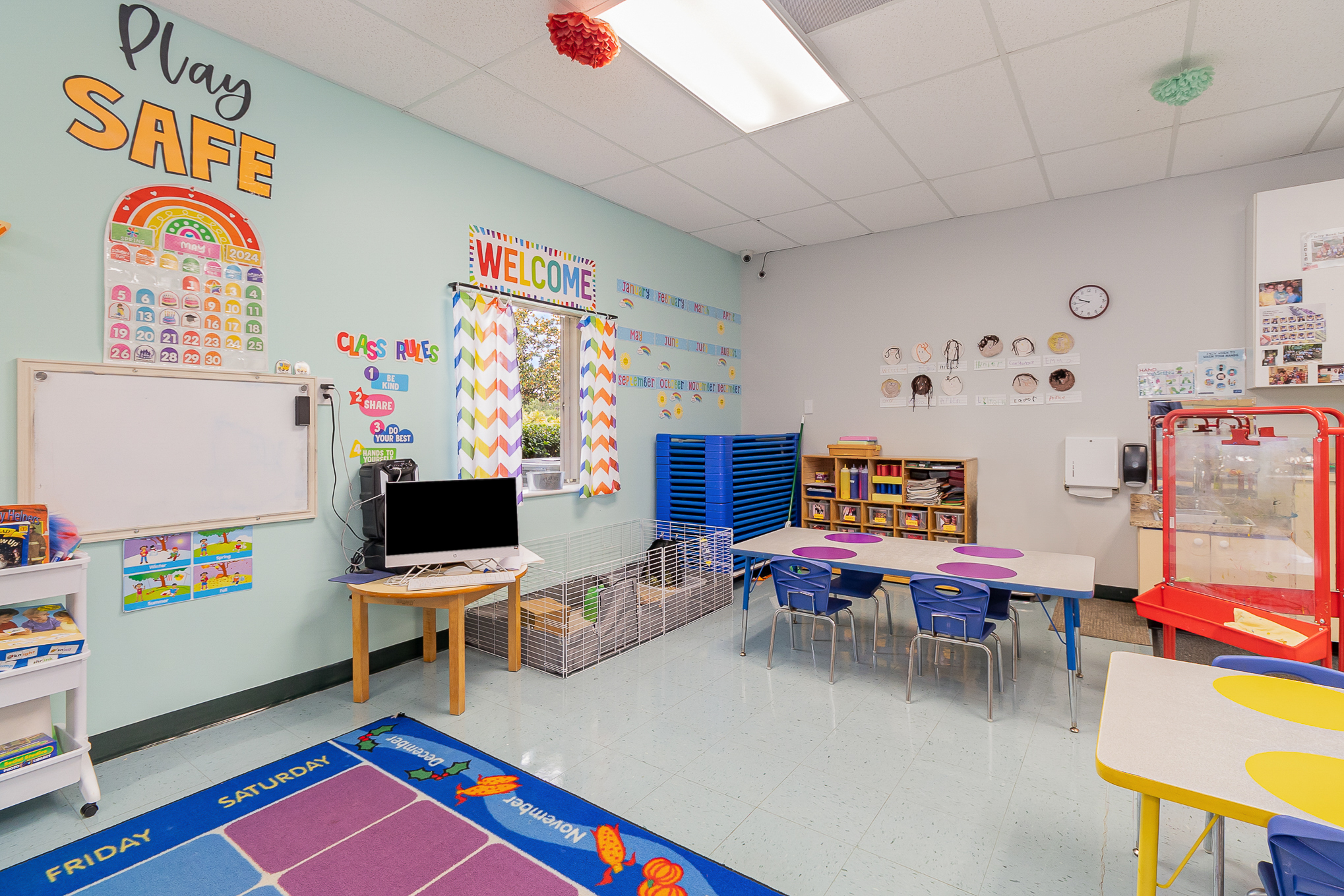 A bright Jelly Bean Junction classroom with natural light, low wooden shelves, and a reading nook
