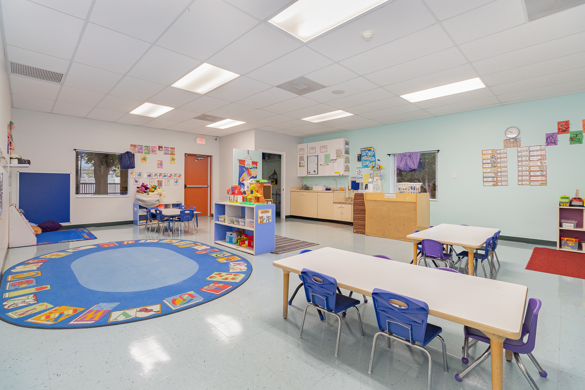 VPK prekindergarten classroom with letter and number displays, learning centers, and a circle time area
