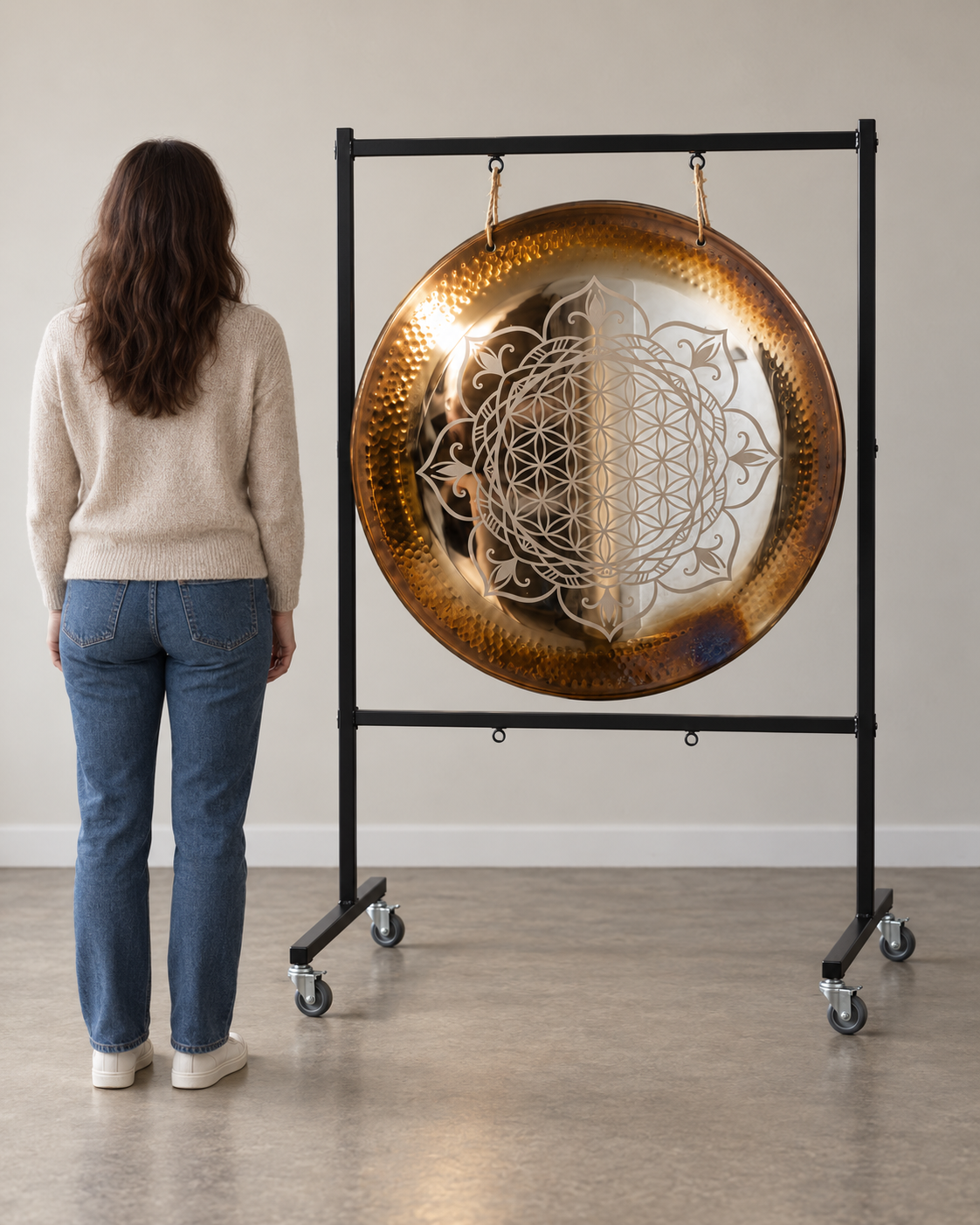 Black powder-coated steel double gong stand holding one 36 inch Flower of Life gong on wheels, showing human scale and room for a second gong