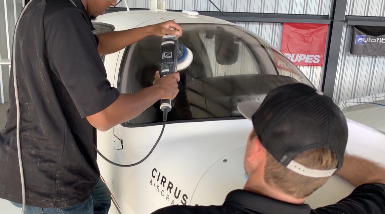 Technicians machine polishing and correcting surfaces on a Cirrus aircraft