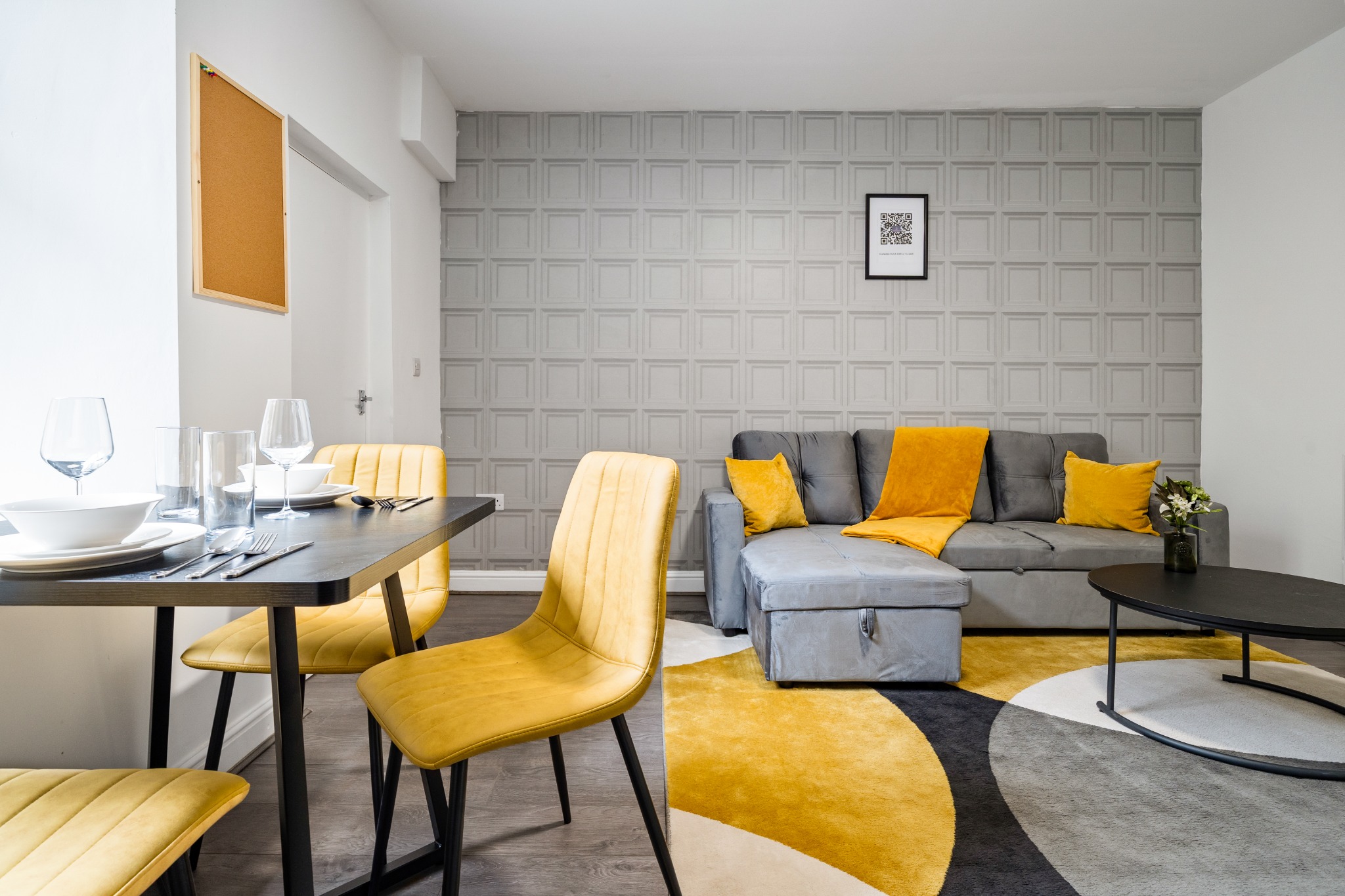 12A Wellington Halifax — open-plan living and dining area with sofa bed and table