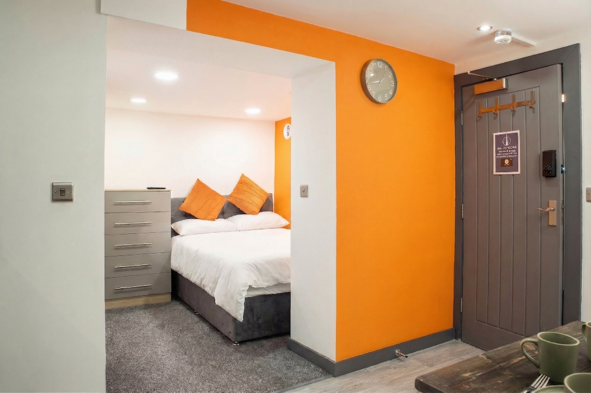Piccadilly 8B — modern studio bedroom with orange feature wall