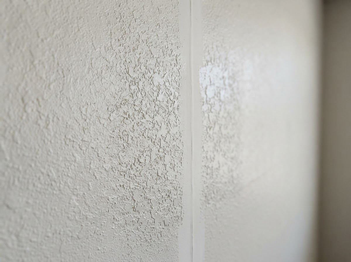 Knockdown drywall texture matched across a repaired section