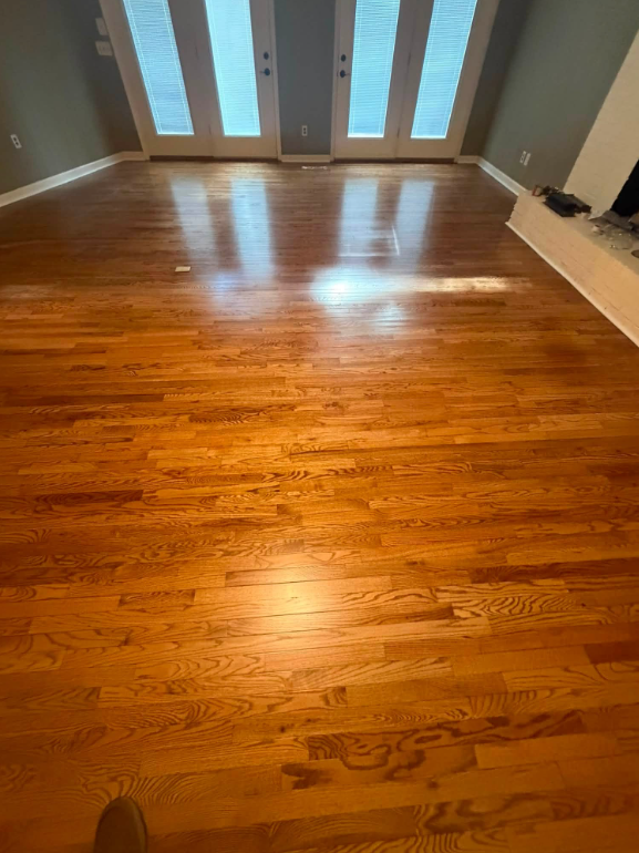 Warm living room with newly installed and refinished hardwood flooring