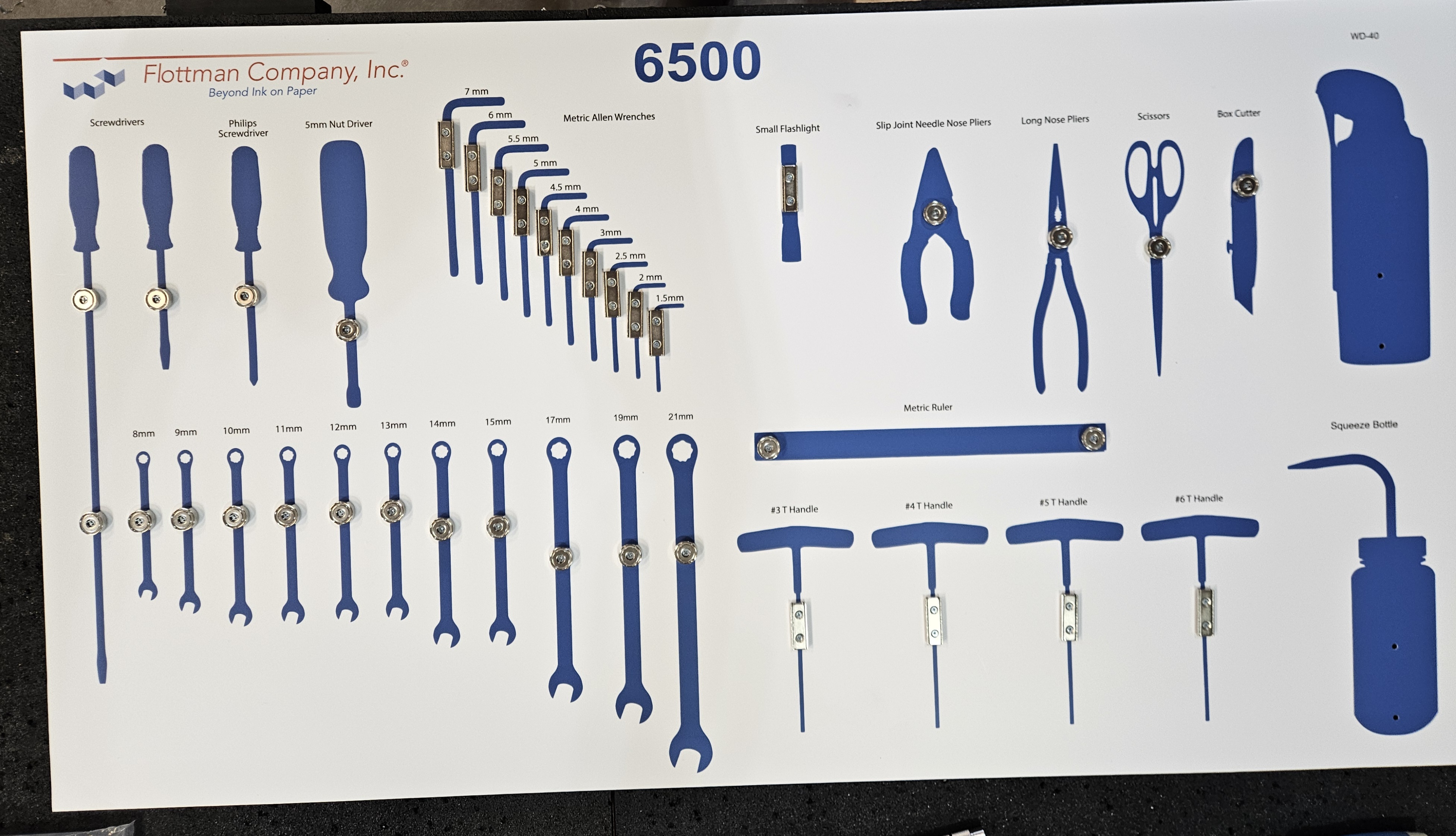 Flottman Company 6500 precision tool shadow board with blue silhouettes and magnetic retention blocks for metric Allen wrenches, screwdrivers, pliers, scissors, and wrenches