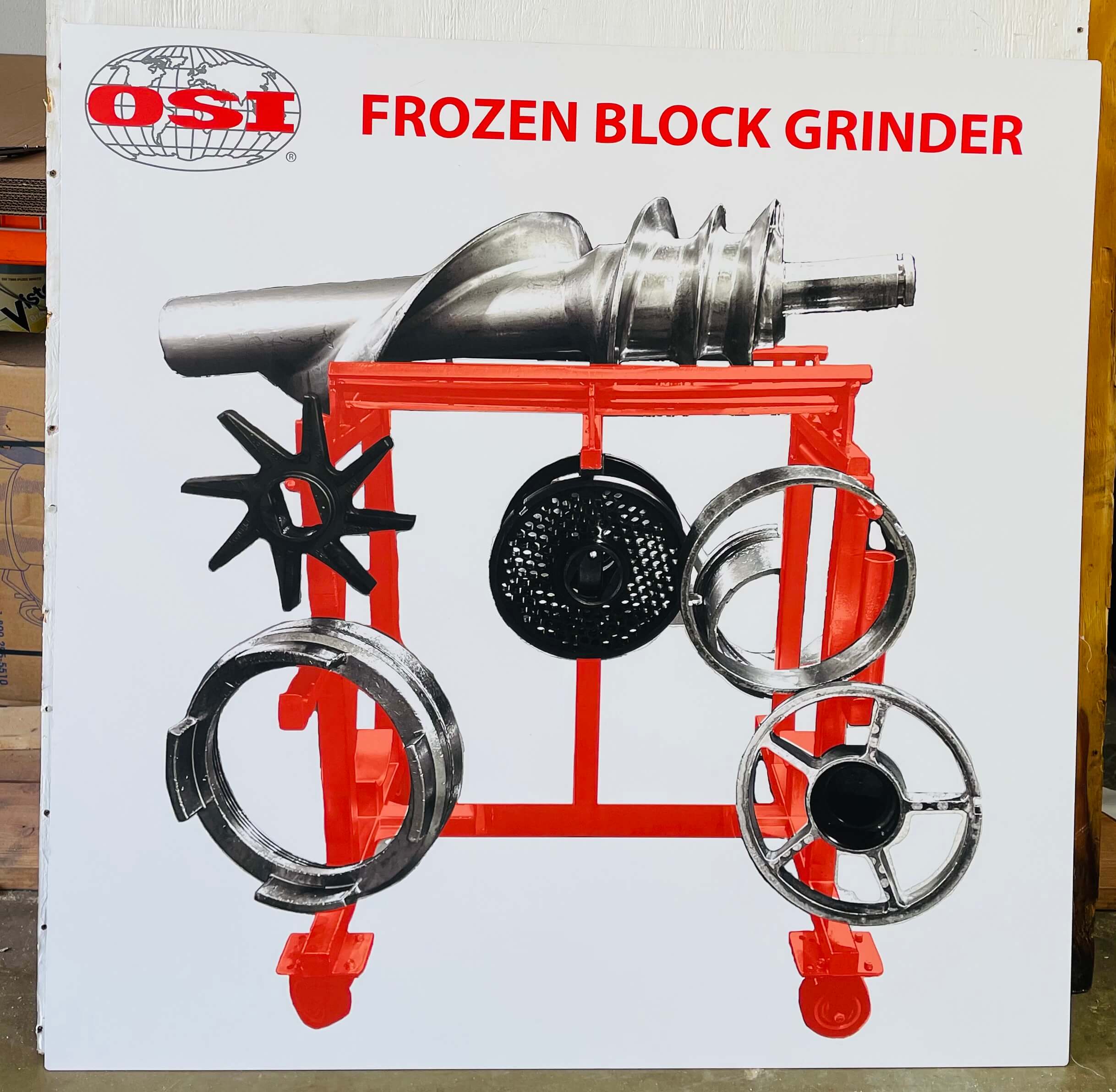OSI Frozen Block Grinder changeover and tooling board with large auger screw, cutter blade, perforated plates, and clamping rings
