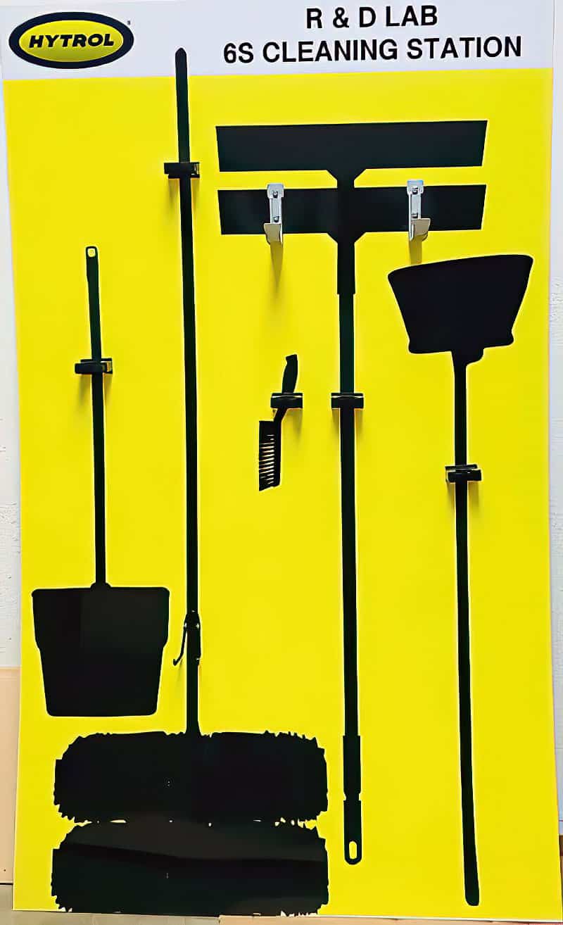 Hytrol R&D Lab 6S Cleaning Station high-contrast yellow shadow board with heavy-duty tool mounting clamps and black silhouettes