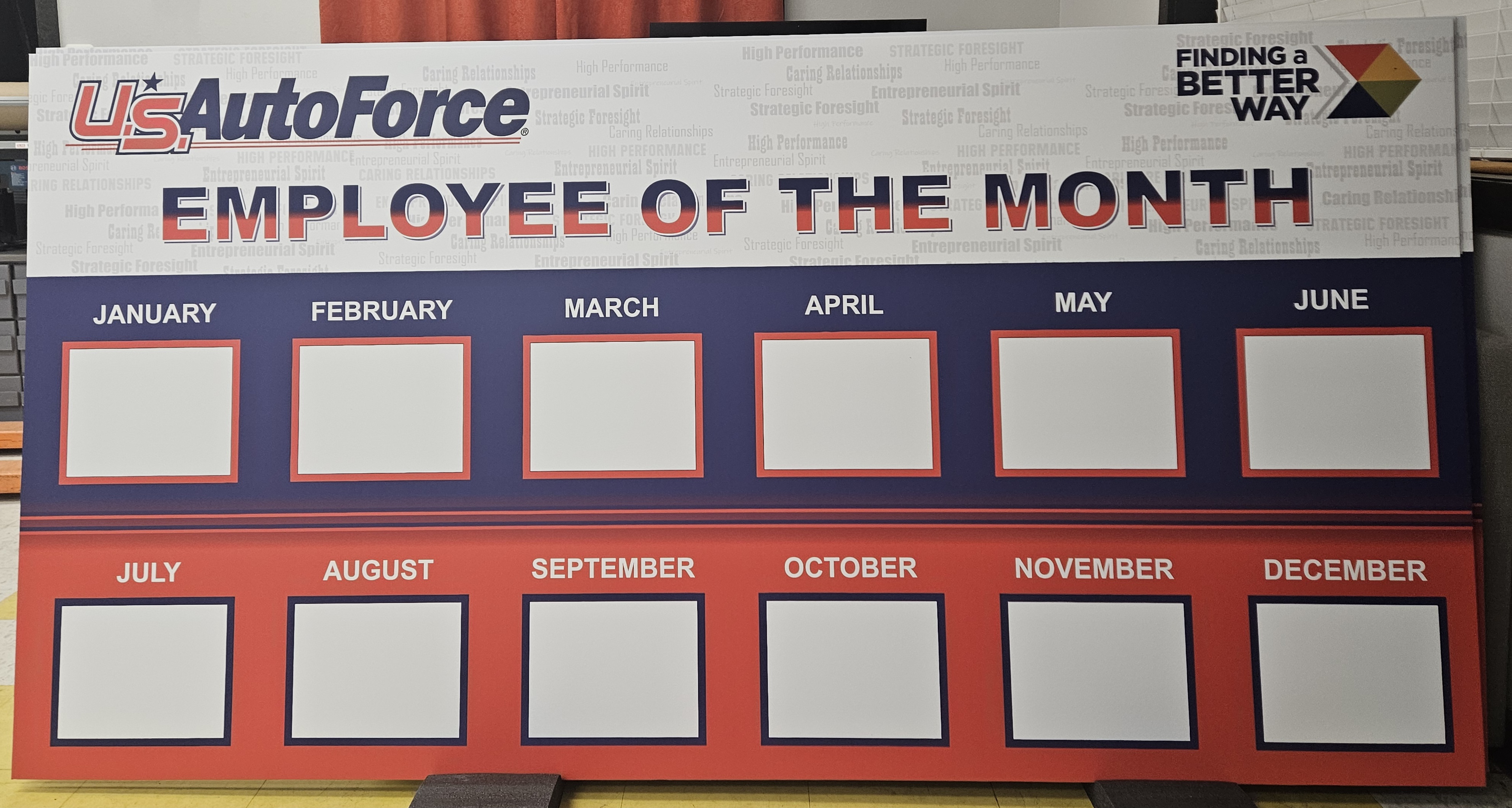 U.S. AutoForce Employee of the Month visual recognition board with twelve monthly display frames, corporate core values watermark, and branded header