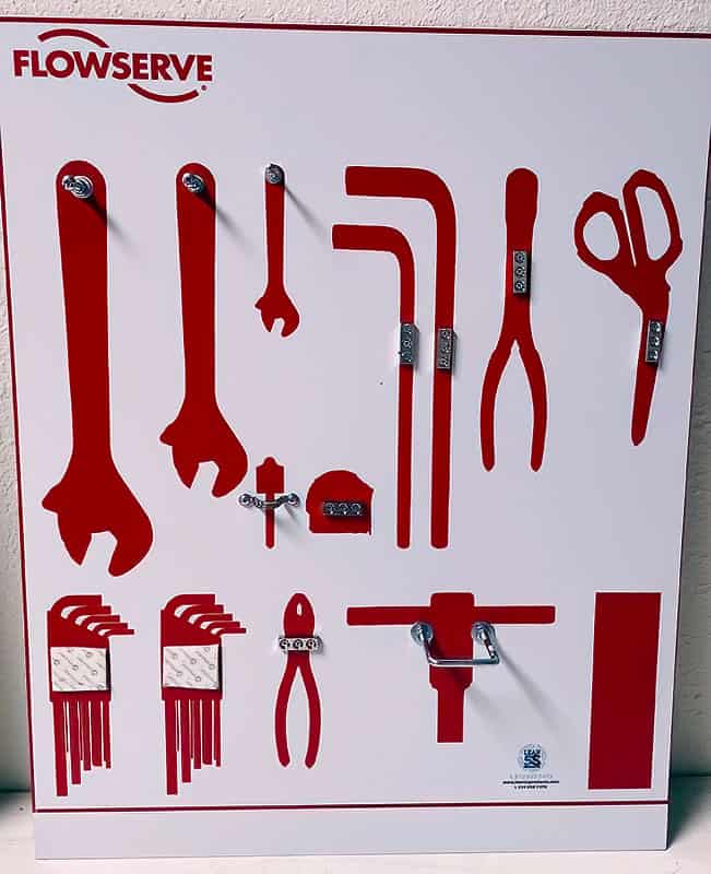 Flowserve Tool Shadow Board with red silhouettes and chrome mounting pegs for open-end wrenches, hex key sets, pliers, shears, and tape measure