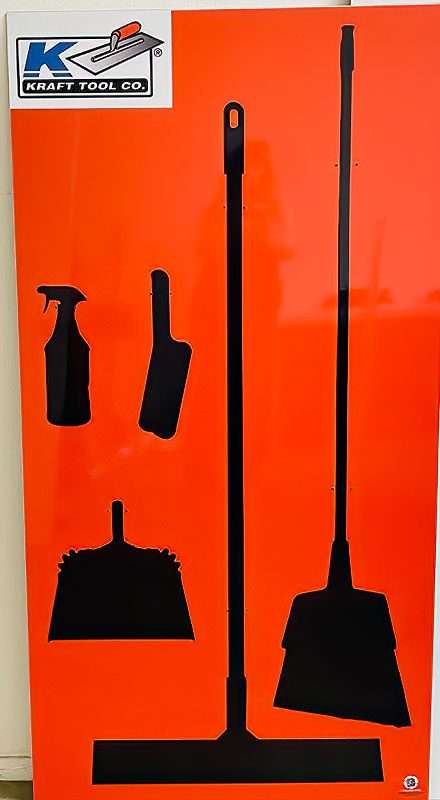 Kraft Tool Co safety orange shadow board with high-contrast black tool silhouettes for floor squeegee, push broom, lobby dustpan, counter brush, and spray bottle