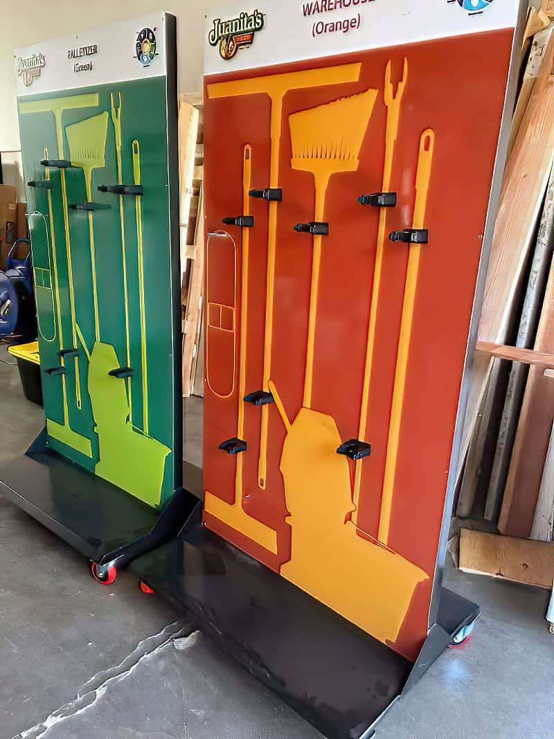 Juanita's Foods color-coded mobile cleaning station carts in green Palletizer zone and orange Warehouse zone with heavy-duty locking casters