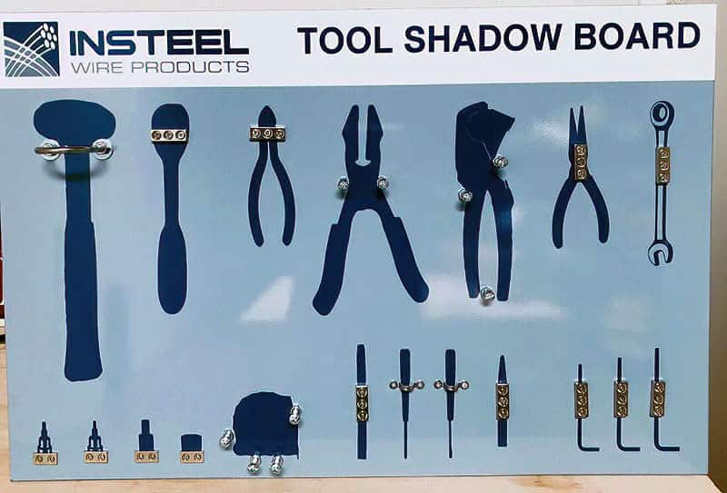 Insteel Wire Products Tool Shadow Board in light steel blue with dark navy tool silhouettes, chrome clips for mallet, ratchet, wire cutters, pliers, punches, and hex keys