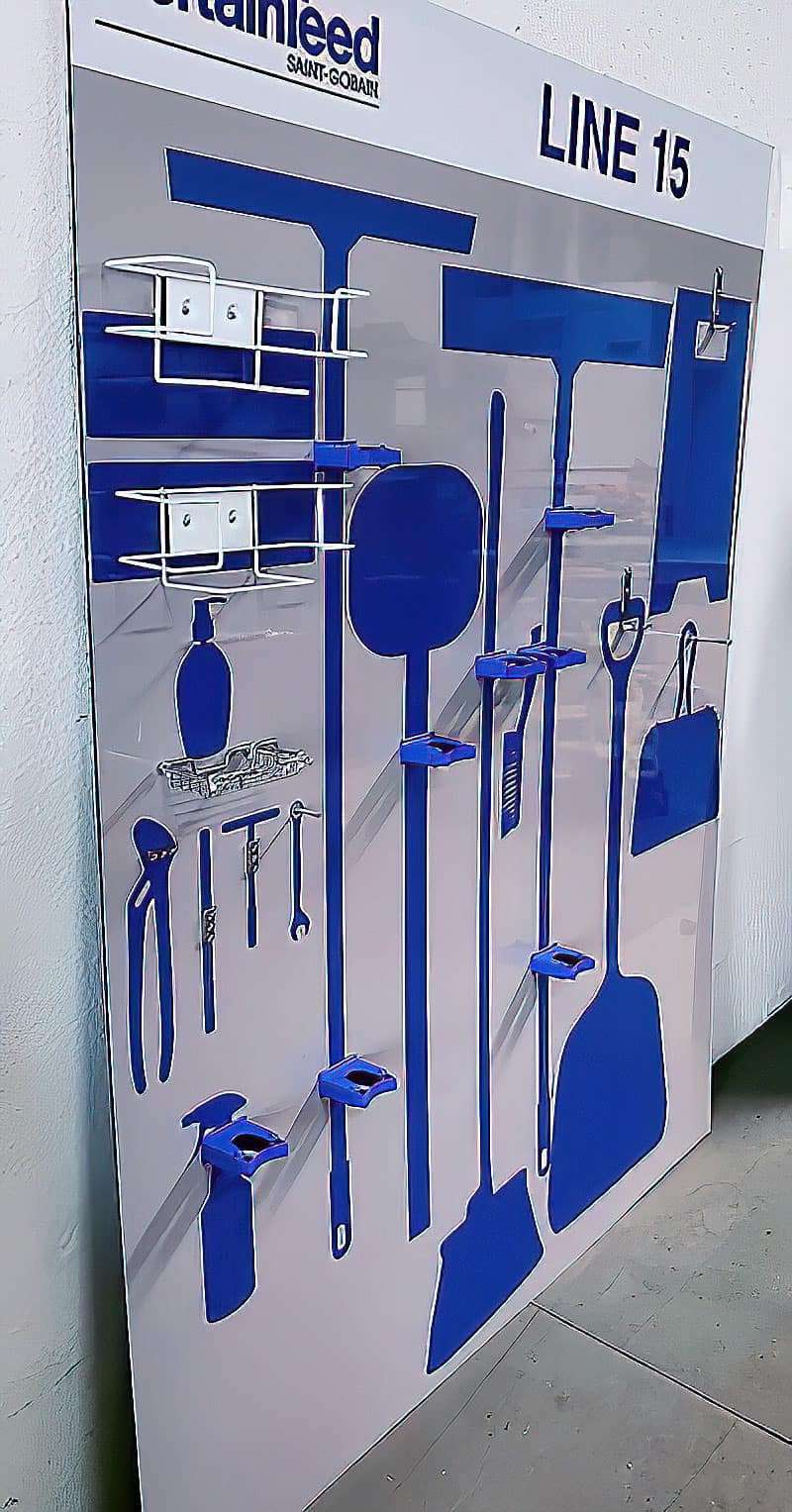 CertainTeed Saint-Gobain Line 15 industrial shadow board with royal blue tool silhouettes, dual wire baskets, and precision tool brackets