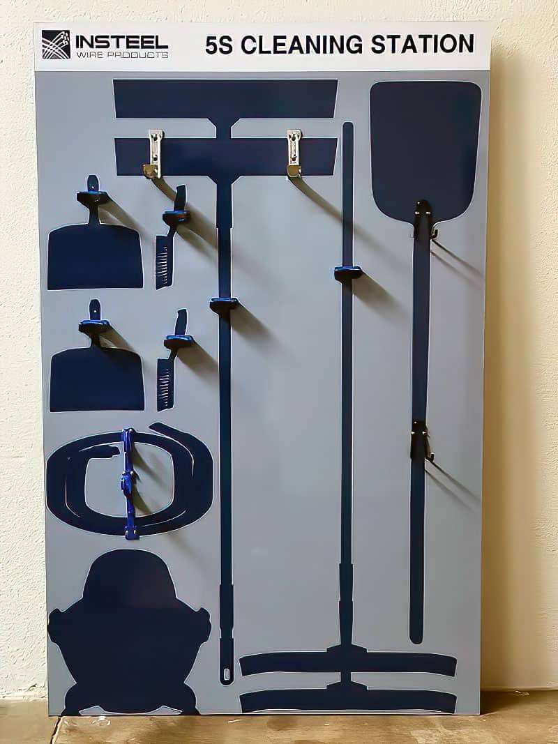 Insteel Wire Products 5S Cleaning Station industrial board with stainless brackets and dark silhouettes for brooms, shovel, squeegees, and dustpans