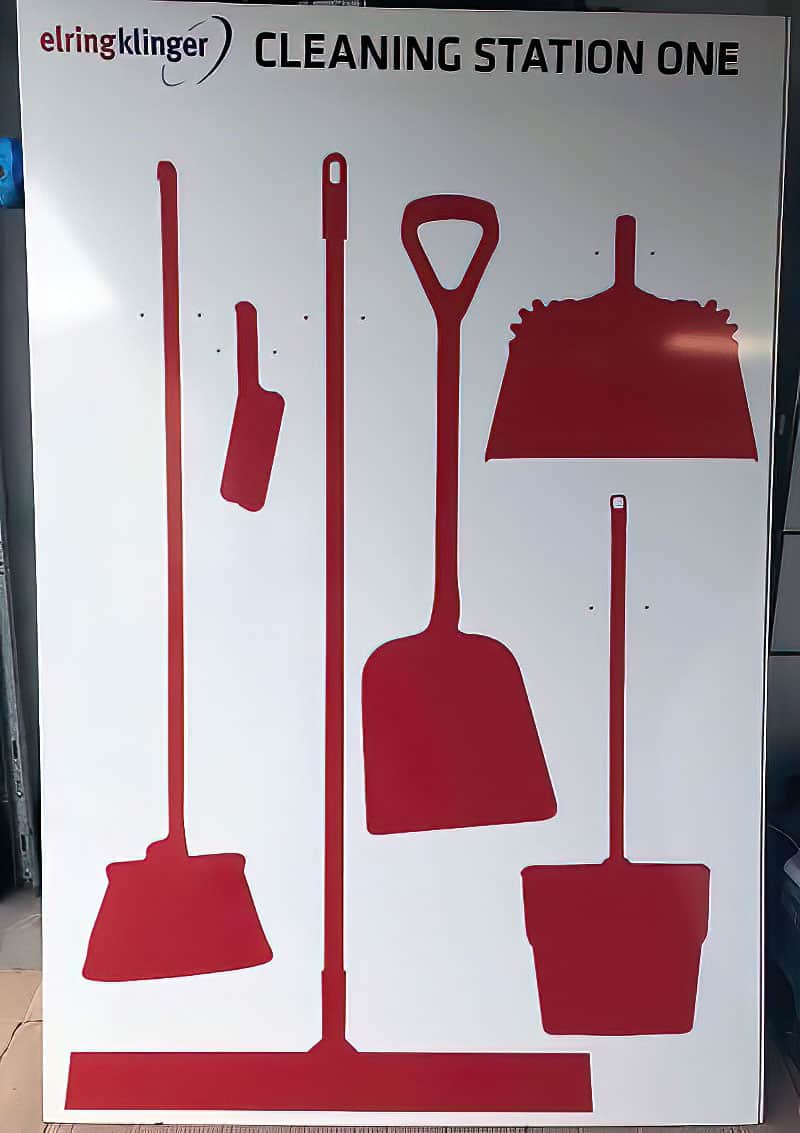 Elringklinger Cleaning Station One shadow board with high-contrast red silhouettes for brooms, dustpan, scraper, and D-handle shovel