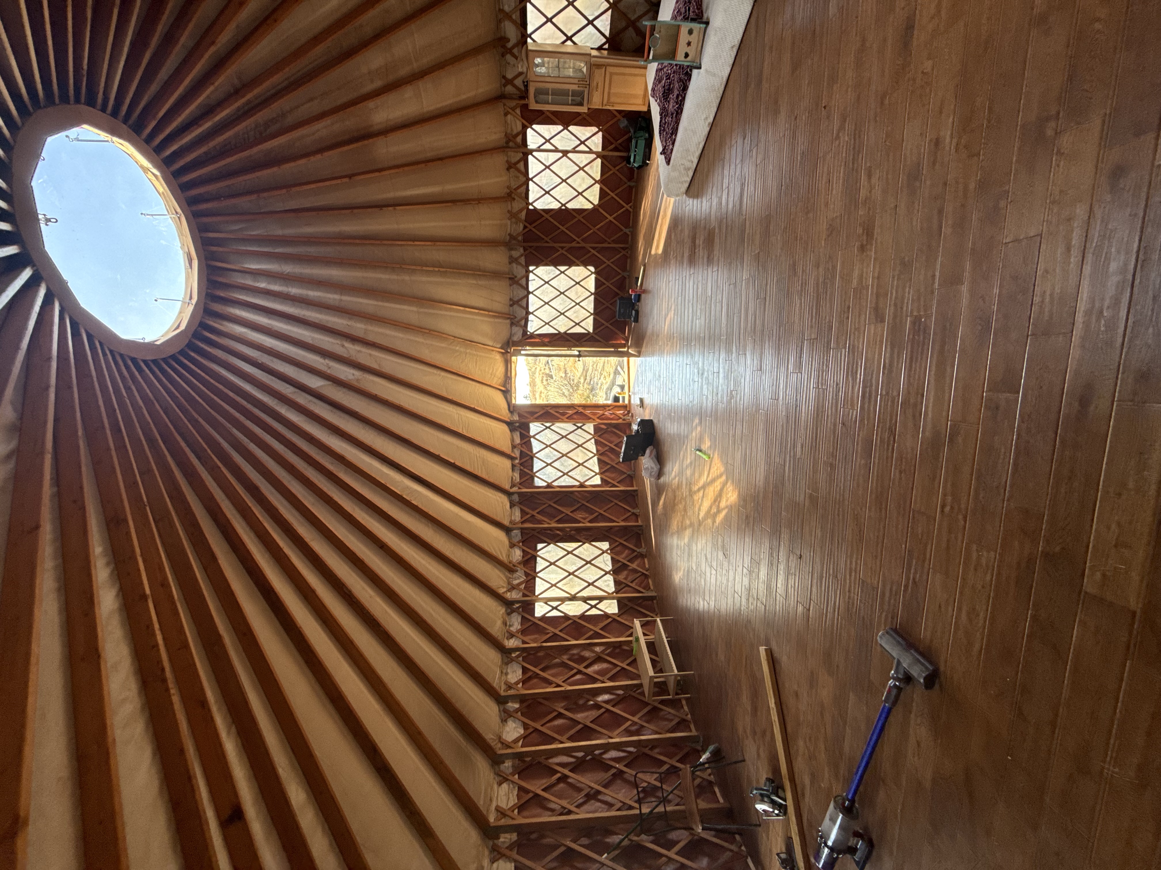 Interior view of Badger Mountain Yurt showing the timber lattice walls, domed ceiling, and wood floors