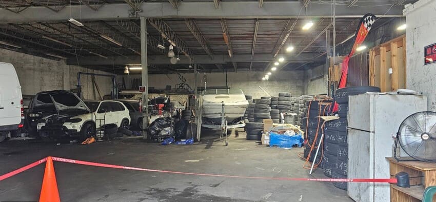 DSJ Tire & Automotive Center shop interior with repair bays and tire inventory