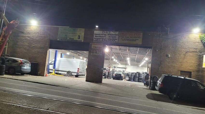 DSJ shop exterior at night showing open garage bays and service area