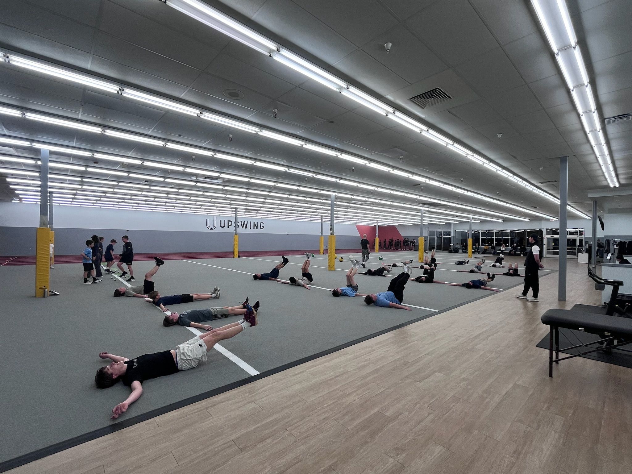 UPSWING Foundation indoor facility featuring Mondo sprint track, turf field, and equipment