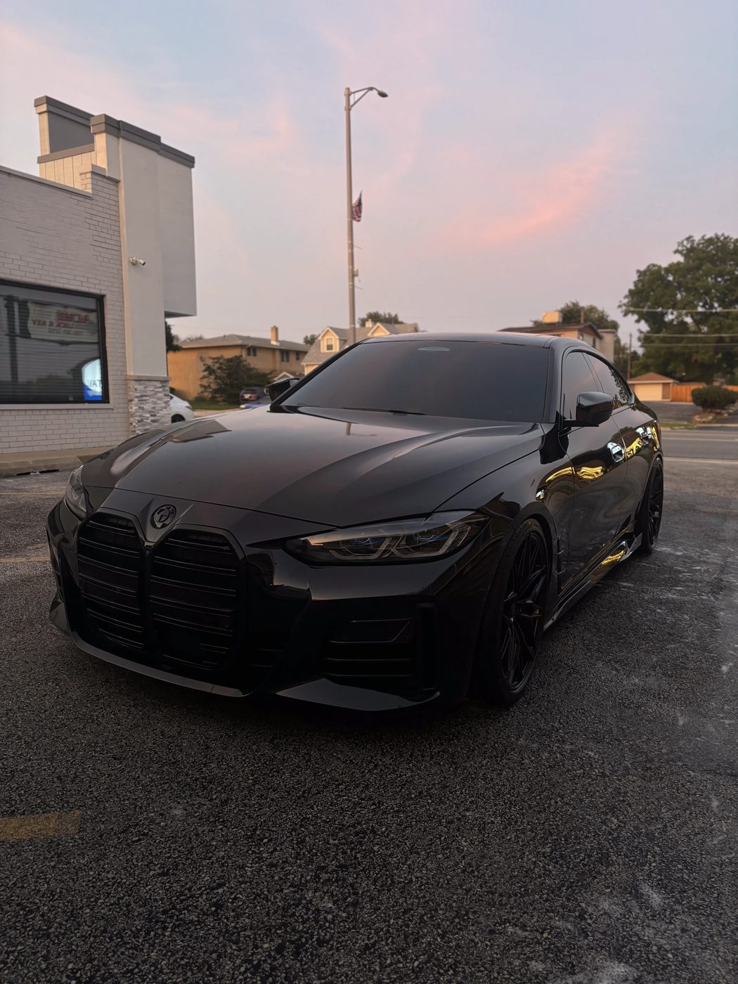 Black BMW exterior detail parked at sunset with deep gloss finish