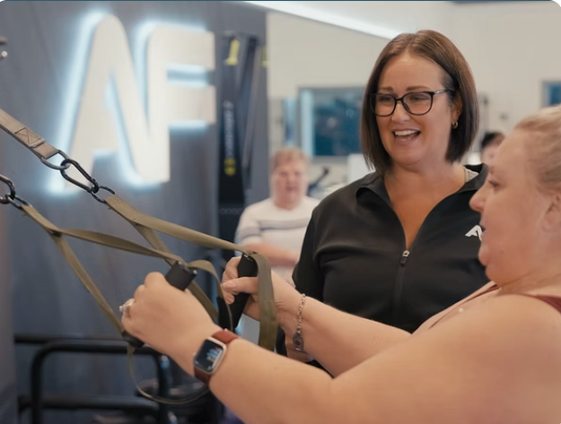 Anytime Fitness Clayton Heights coach guiding a client through assisted suspension strap training