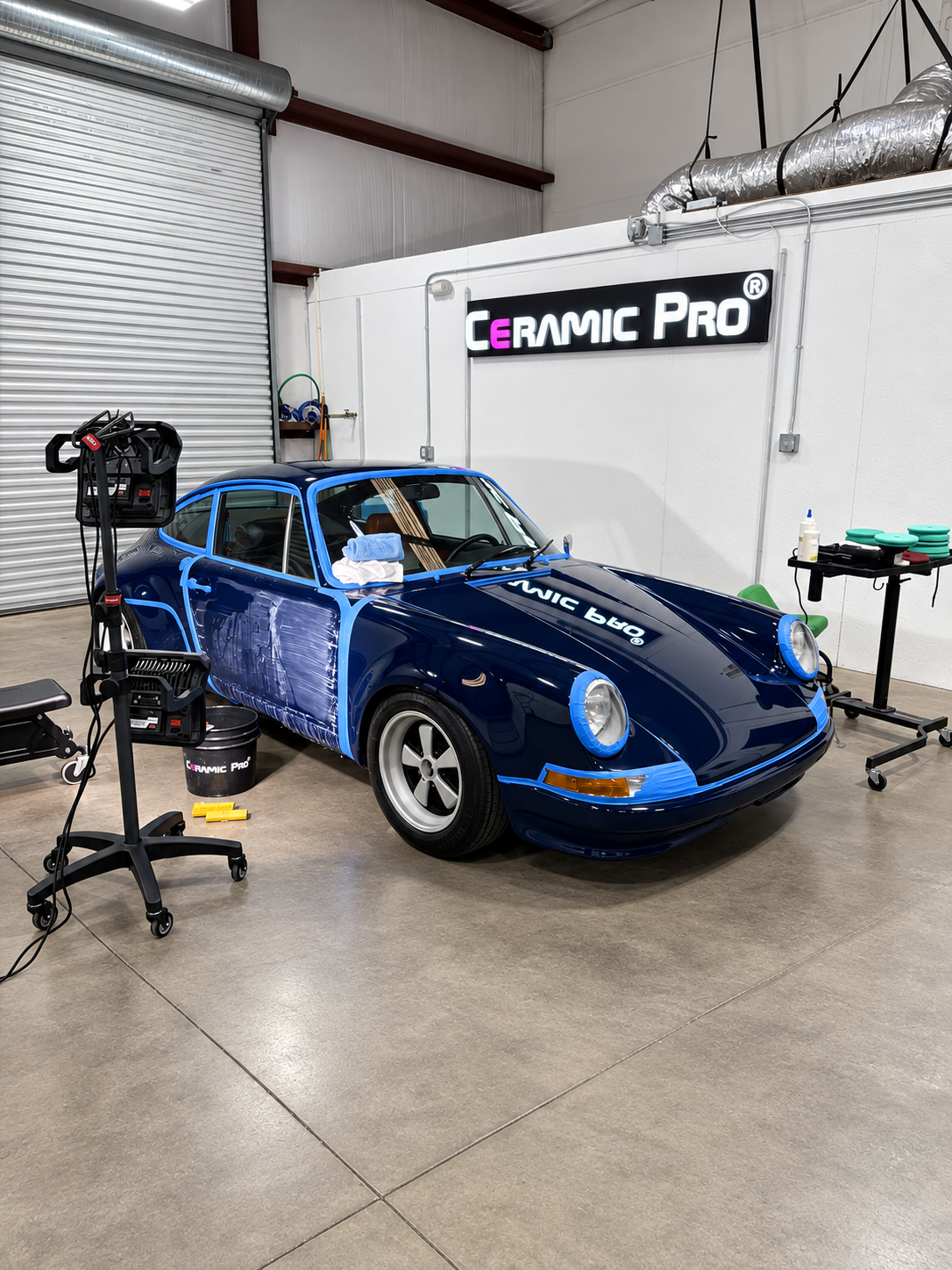 Ceramic Pro Elite Dealer facility — blue Porsche 911 undergoing meticulous surface preparation