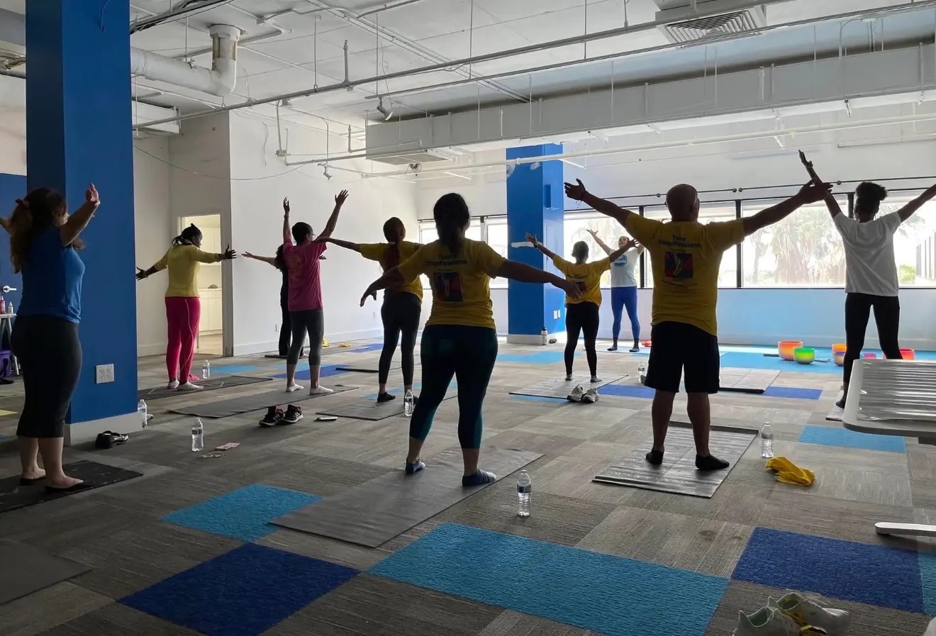 Chiquita Yoga Corporate Group Class Sara Grossman leading a corporate and community group yoga class indoors