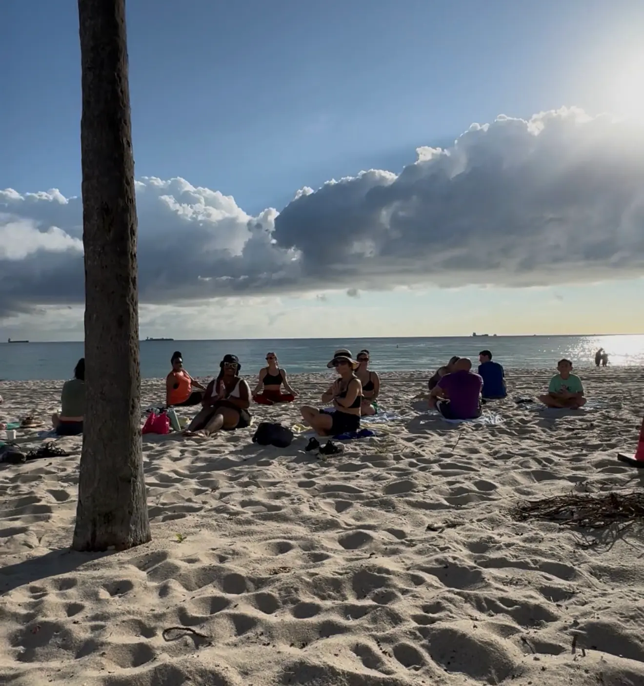 Beach Yoga Practice with Sara Grossman Group yoga class practicing mindfulness and meditation on the beach
