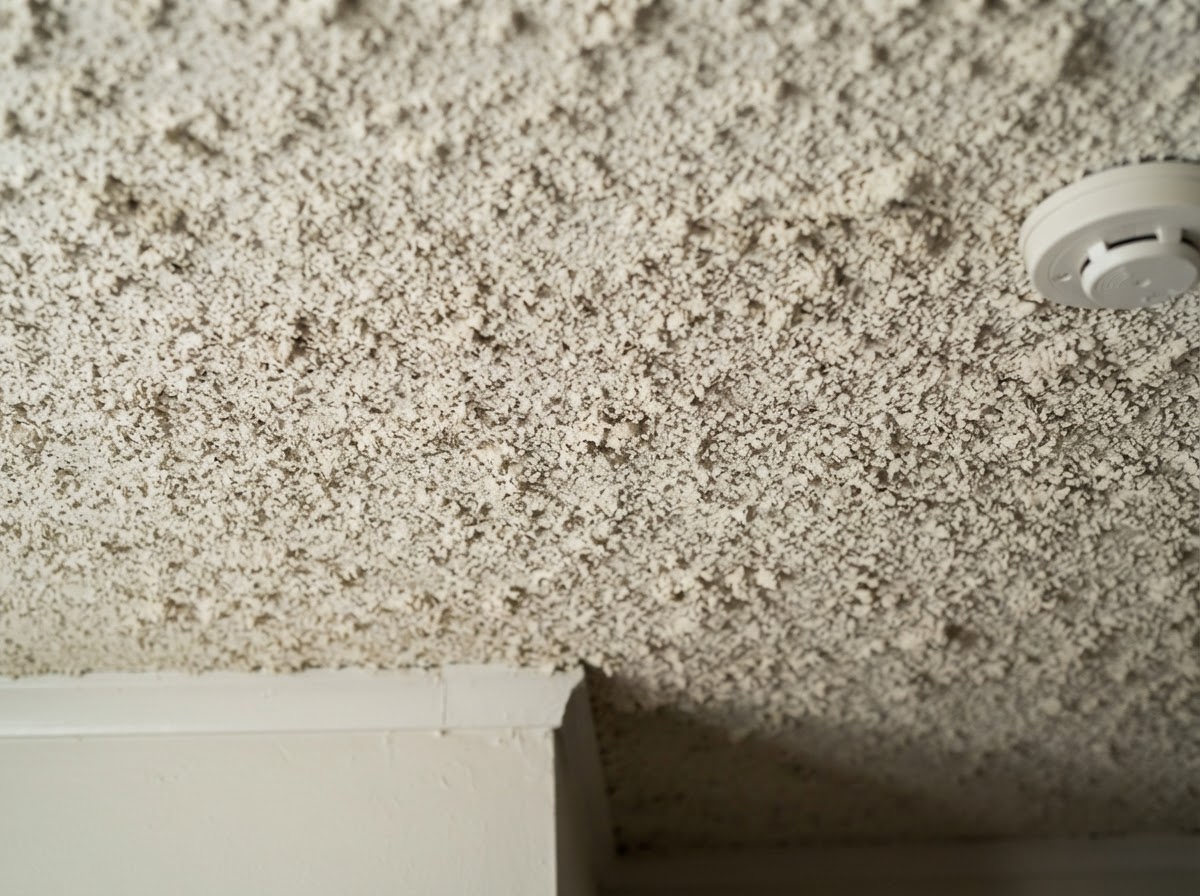 Close-up of acoustic popcorn ceiling texture before removal