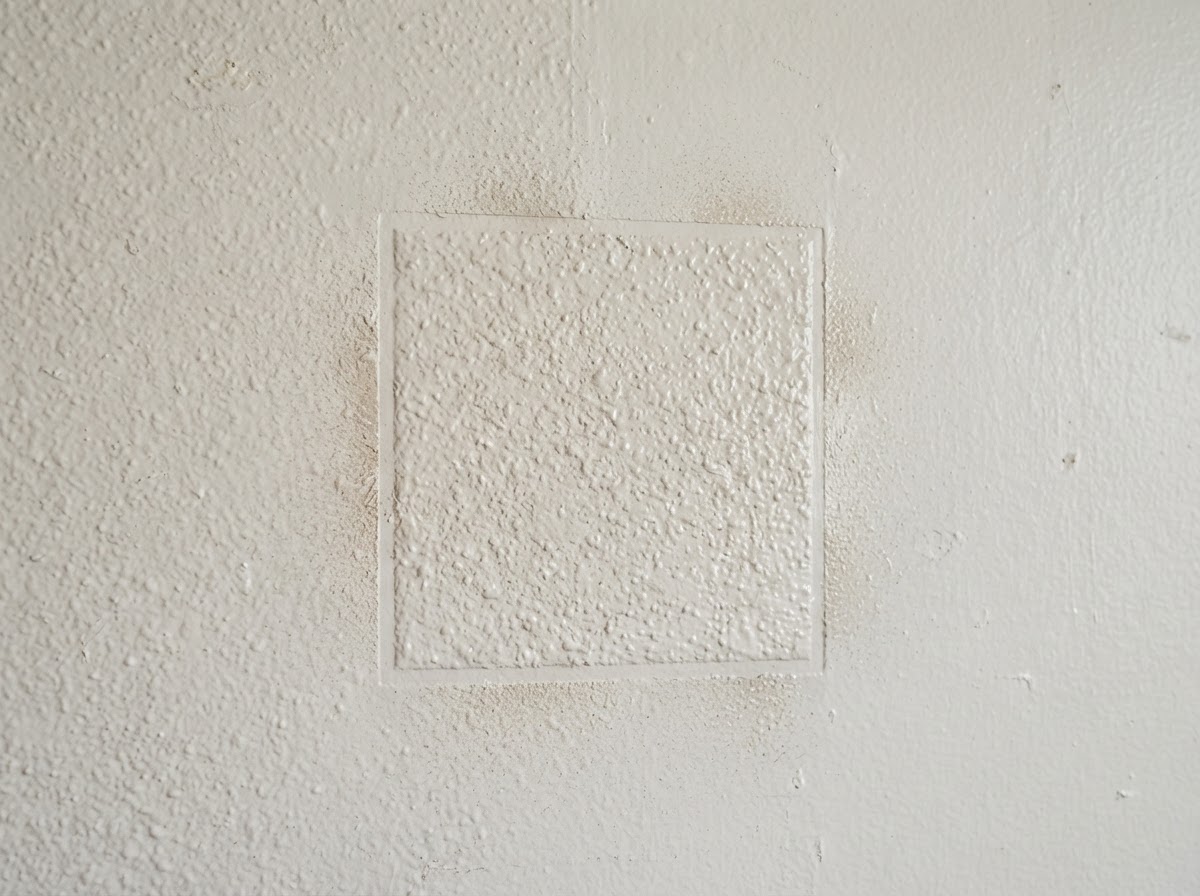 Texture matching detail blending a drywall patch into an existing wall