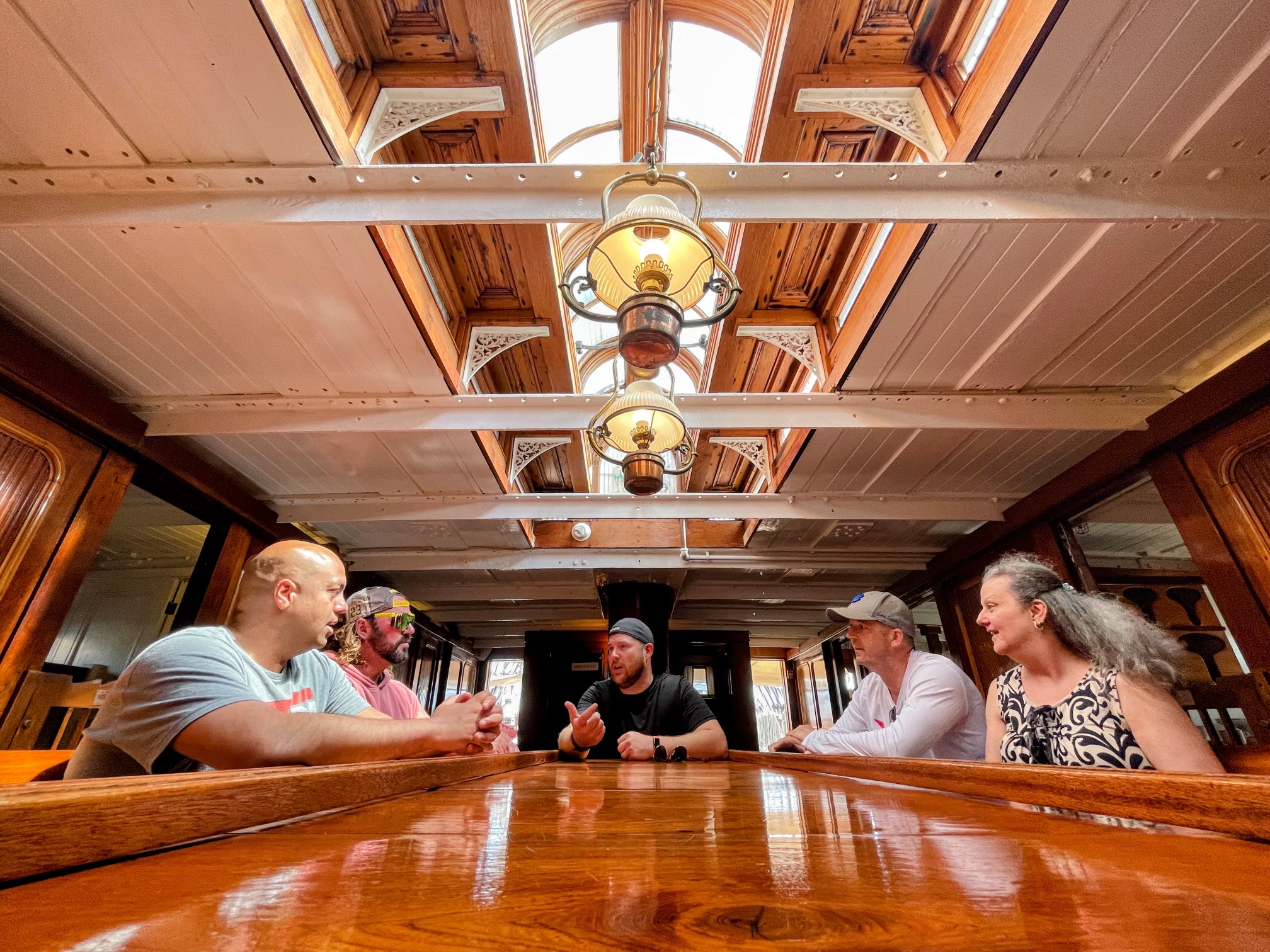 Adventurers in historic tall ship wooden salon