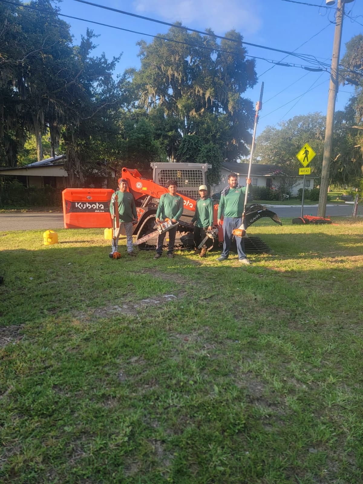 M. & P. Tree Service field crew with Kubota heavy equipment and professional tree cutting tools