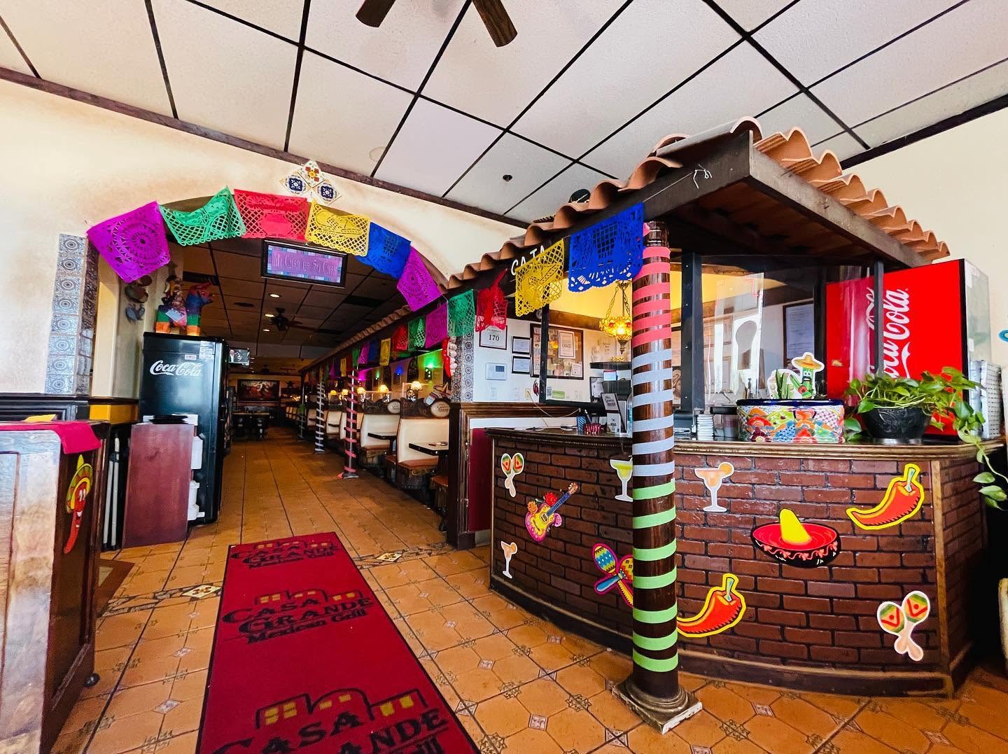 Casa Grande dining room with colorful papel picado and warm brick counter