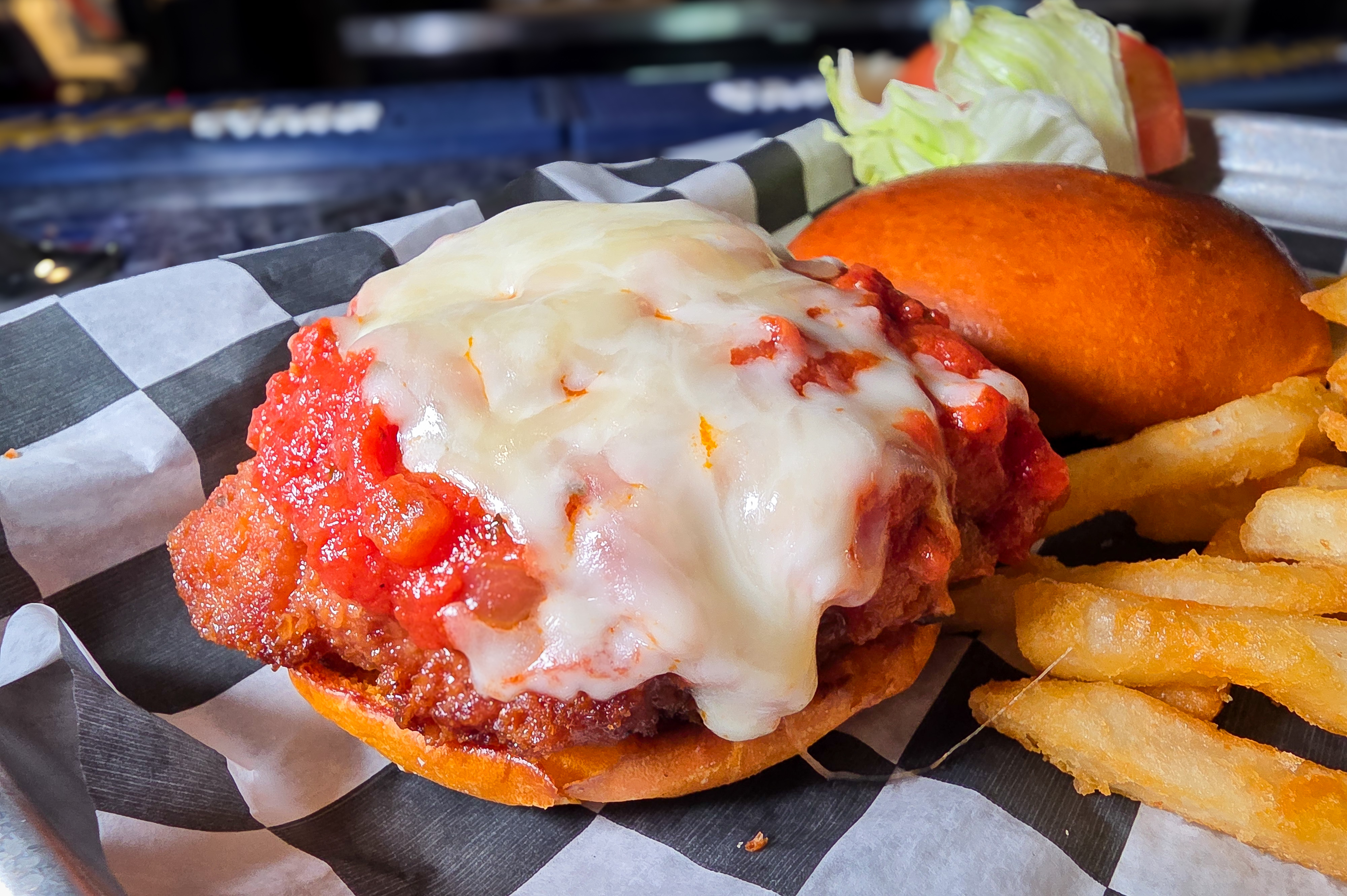 Crispy breaded chicken breast sandwich smothered in marinara sauce and melted mozzarella with french fries