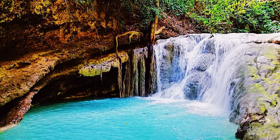 Aguinid Falls turquoise cascade and natural swimming lagoon in Samboan, Southern Cebu