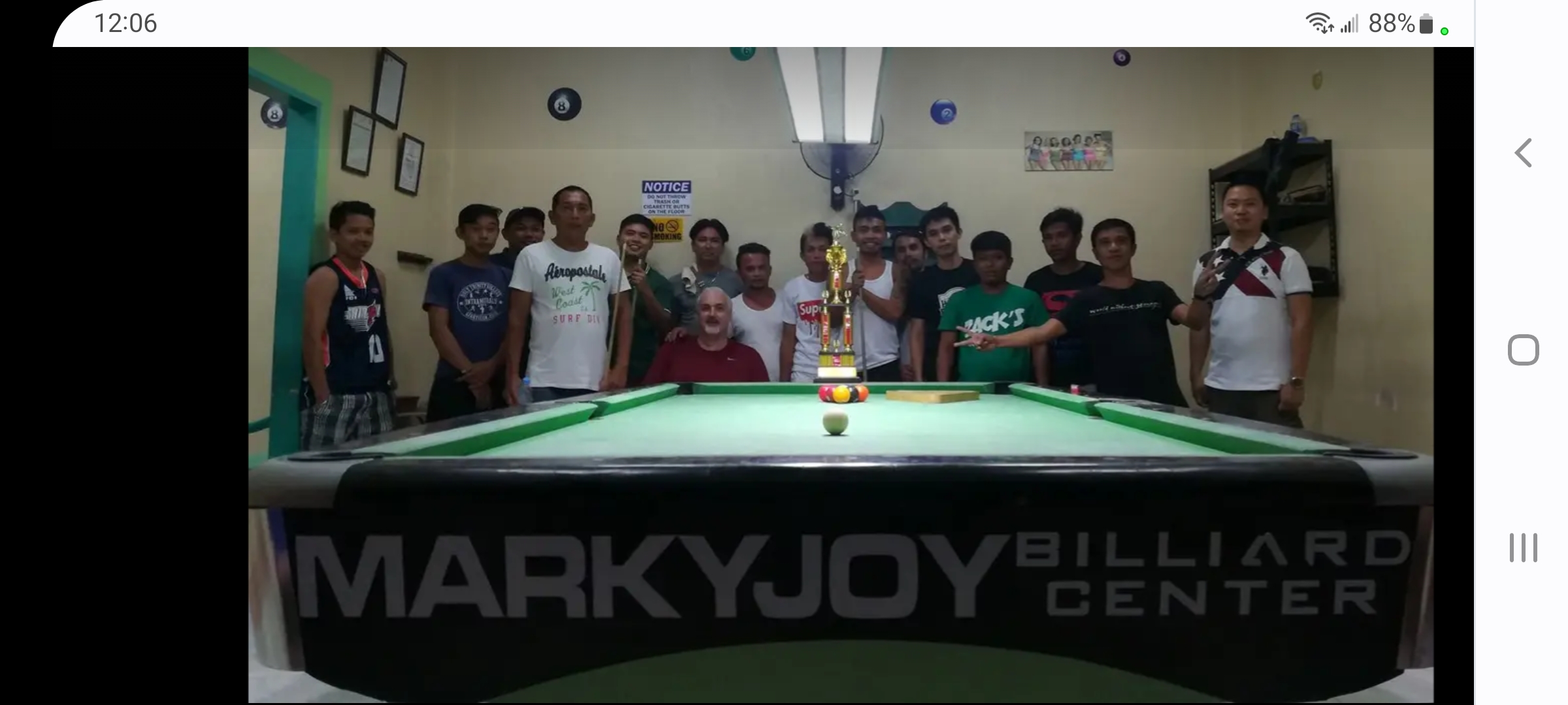 Kray Mims with local community members and tournament trophy at MarkyJoy Billiard Center in Southern Cebu