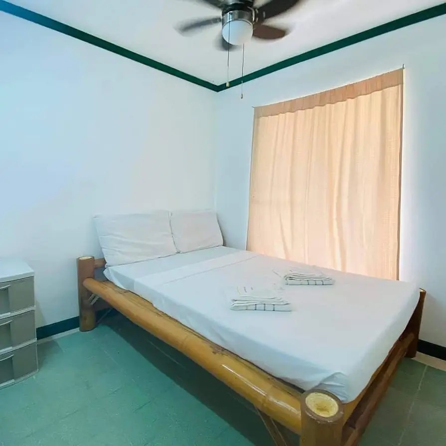 Bedroom at Mims House Cebu featuring handcrafted bamboo bed frame