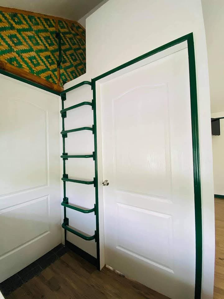 Interior doorway with green architectural trim, wall ladder, and traditional woven amakan bamboo detail at Mims House Cebu