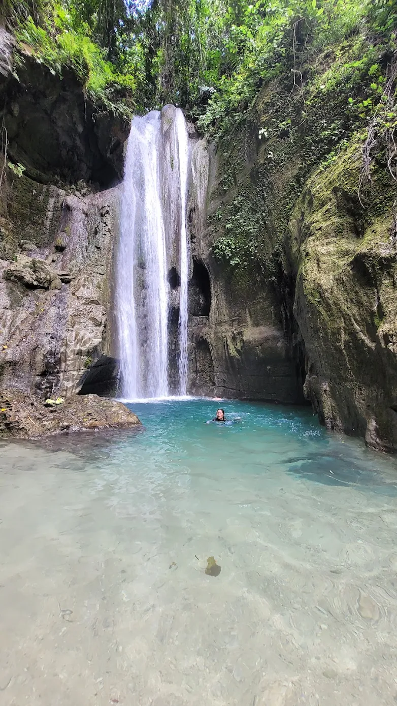 Binalayan Hidden Falls twin cascade pouring into a tranquil pool in Samboan