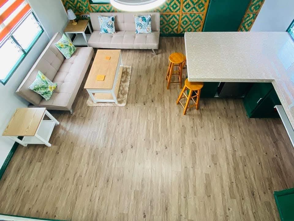Loft aerial view of the living lounge, sofas, and breakfast bar at Mims House Cebu