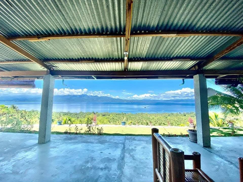 Covered patio with bamboo seating overlooking the Tañon Strait at Mims House Cebu