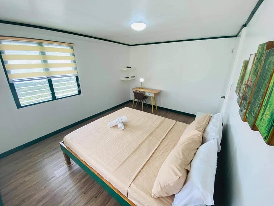 Spacious bedroom at Mims House Cebu with dedicated work desk and sunny window