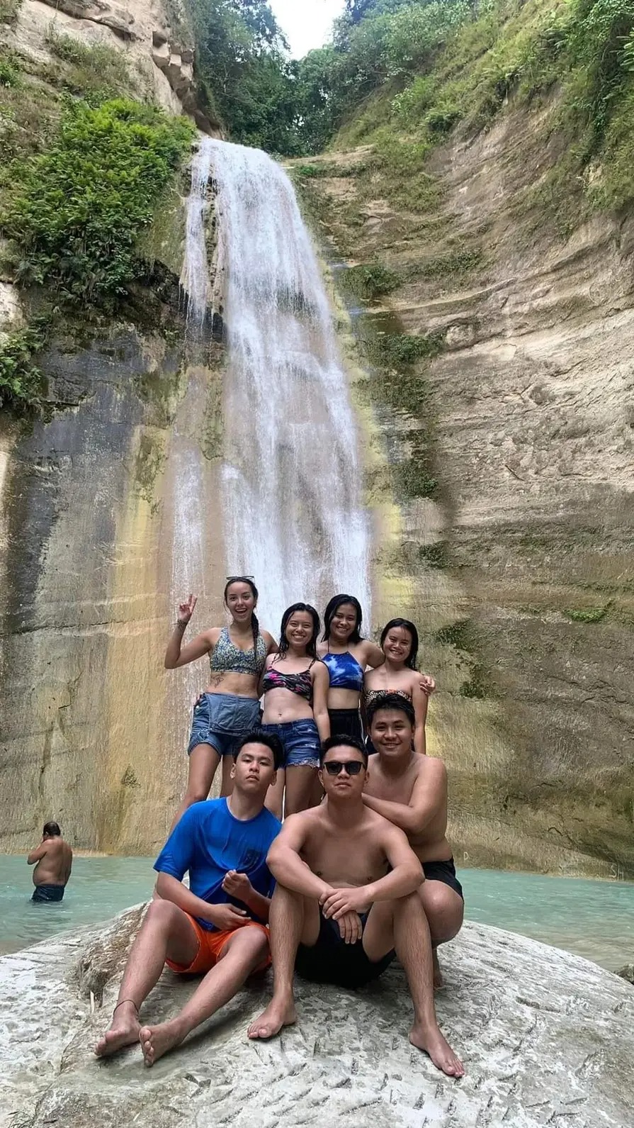 Visitors at a waterfall cascade and swimming pool near Samboan, Southern Cebu